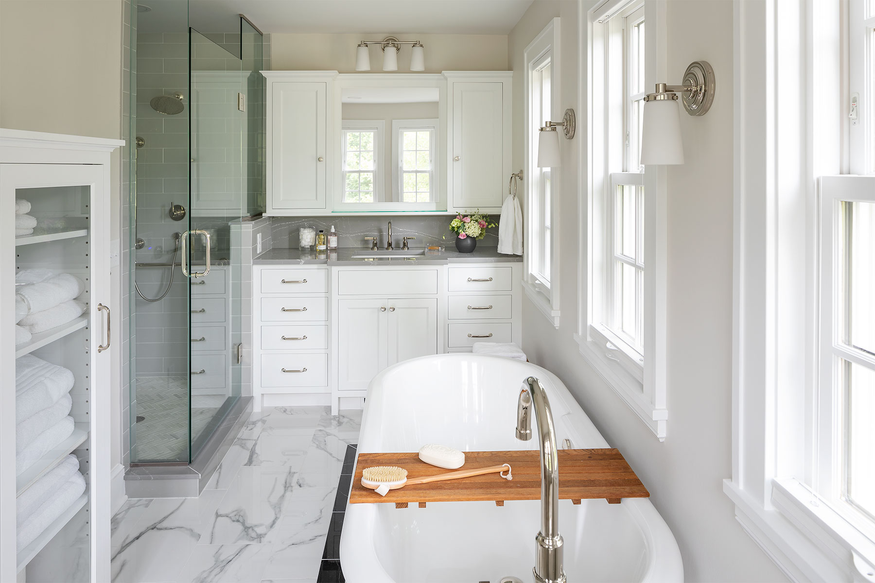 sunny bathroom with white windows and cabinetry