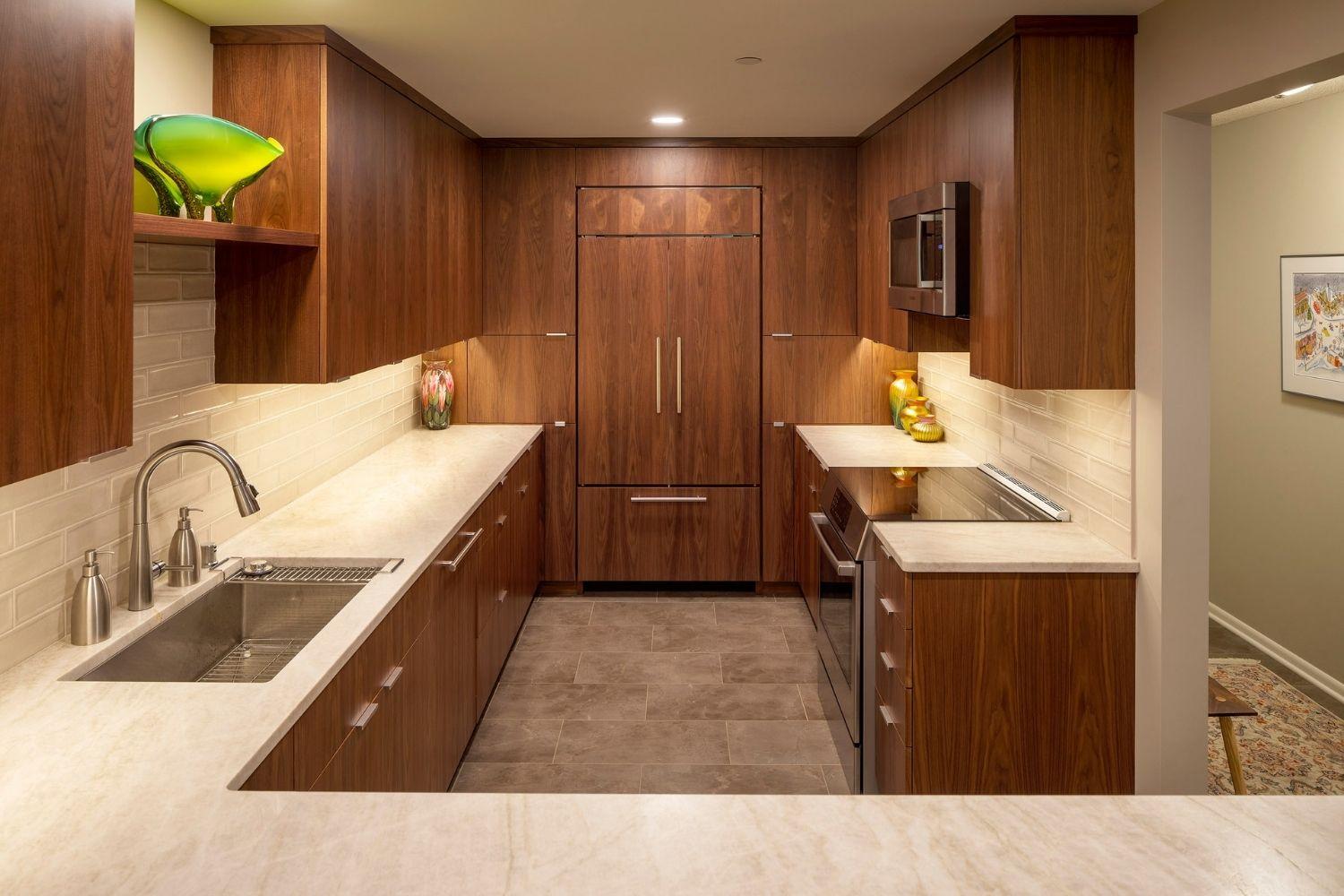 small kitchen with paneled fridge and countertops
