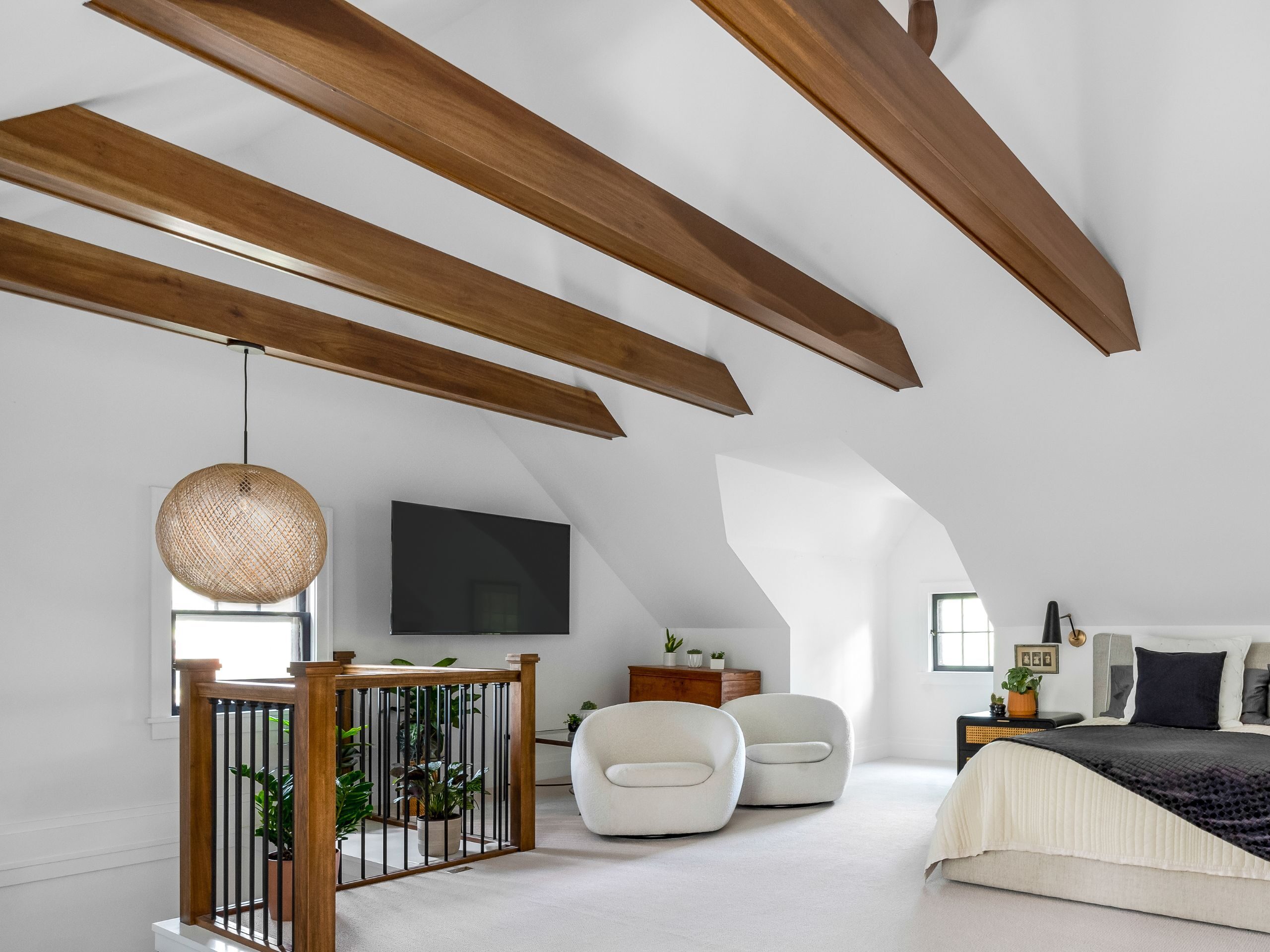 white attic bedroom with wood beams