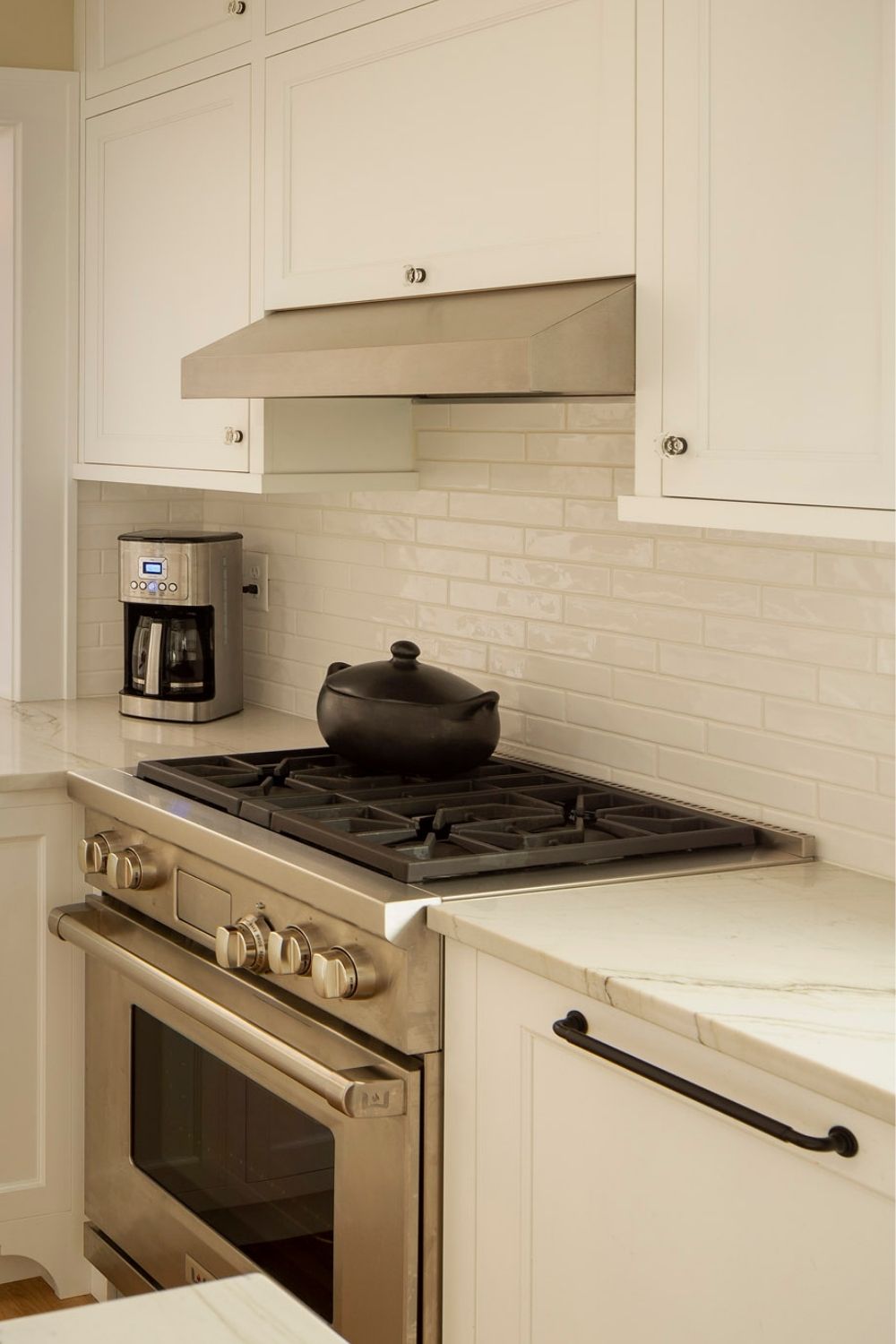 closed cabinets, stove with hood, paneled dishwasher