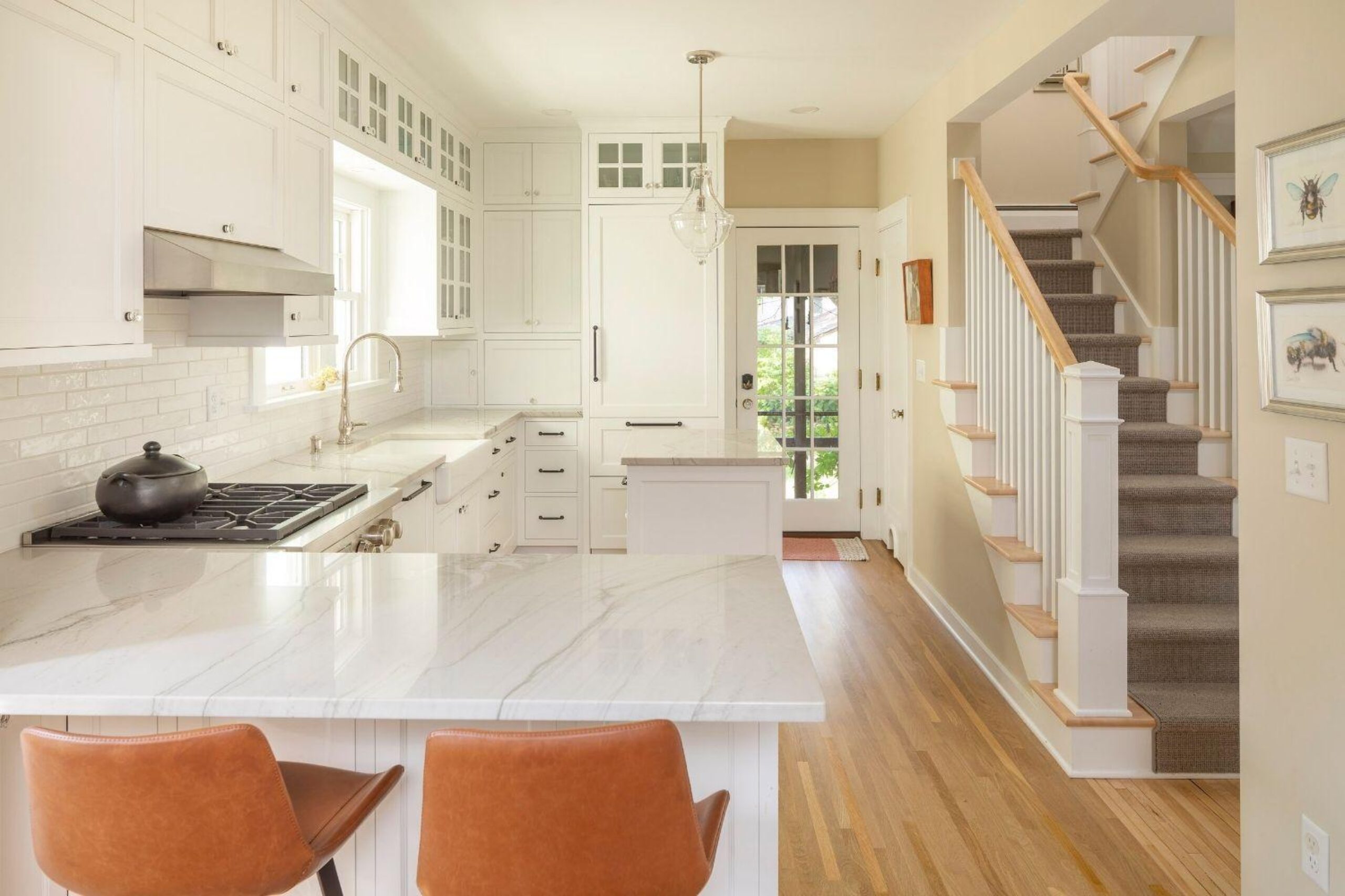 open staircase in bungalow remodel, bar top, paneled appliances, kitchen island
