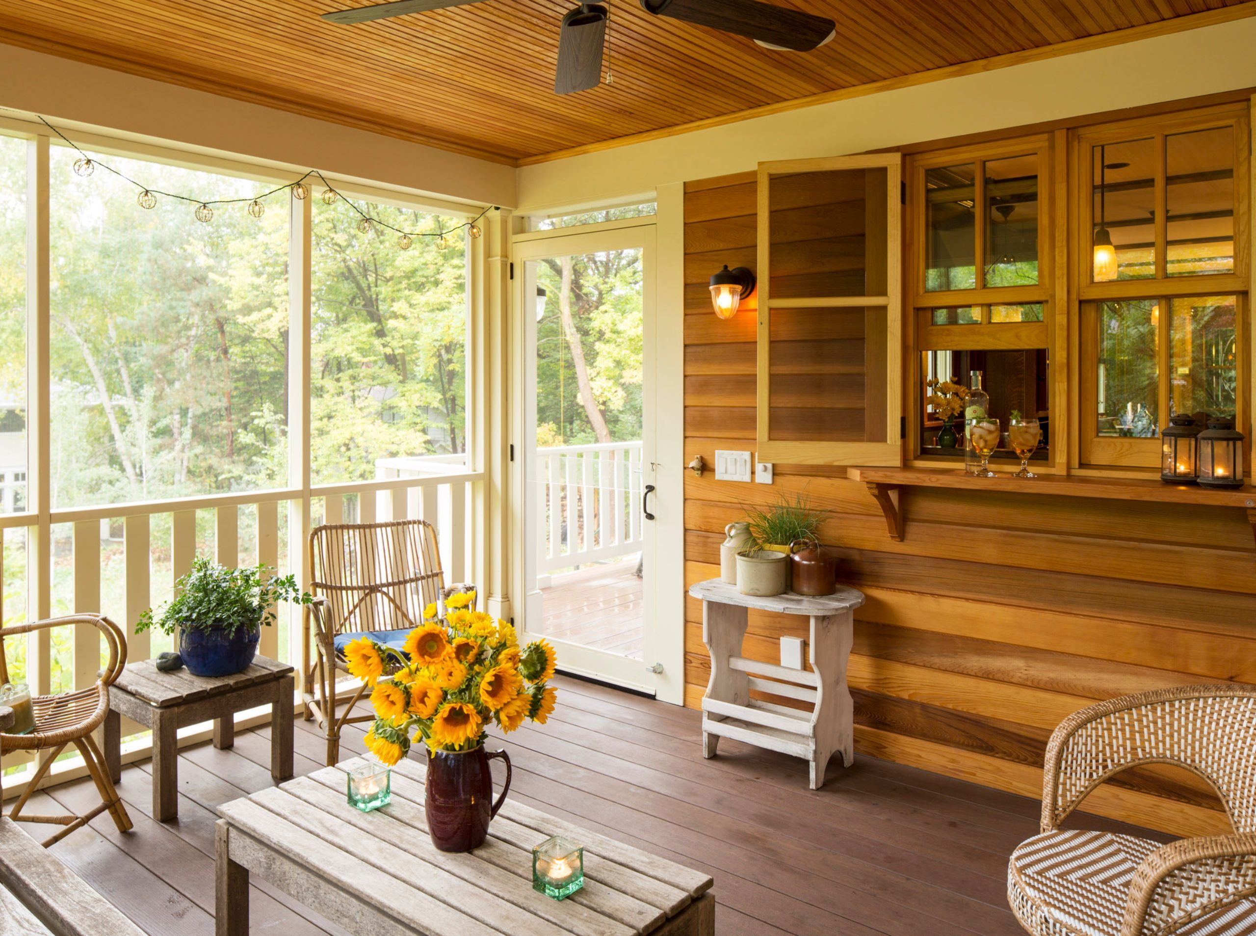 Natural wood floorboards with stained finish, cedar wall with screened-in porch in St. Anthony Park