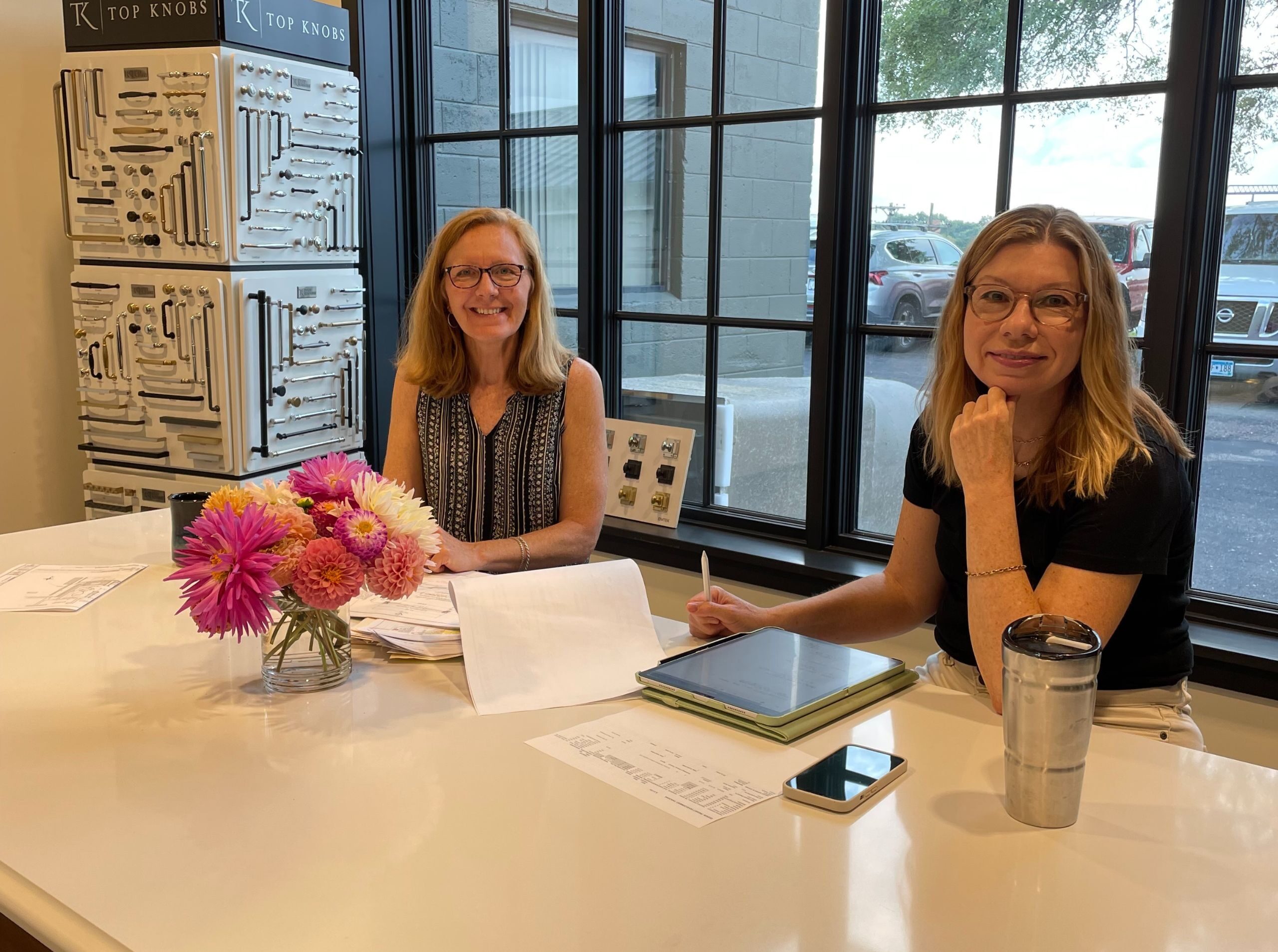 designer and production manager sitting at a work table