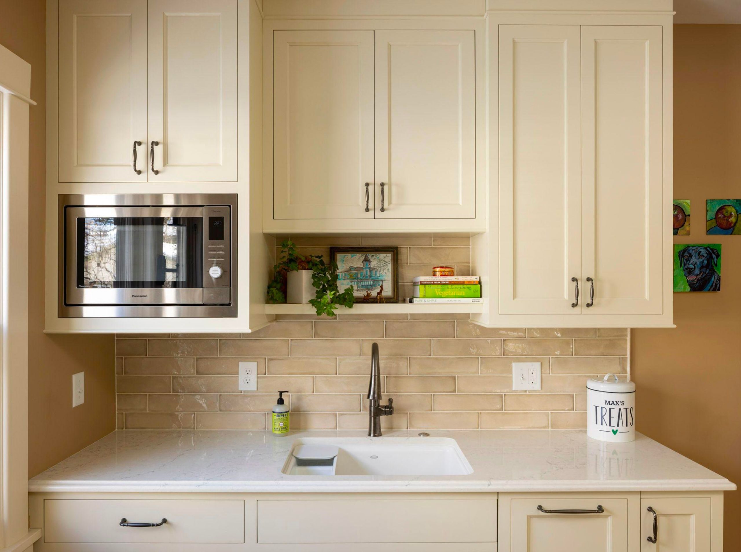 Classic kitchen design with warm white cabinets and black hardware