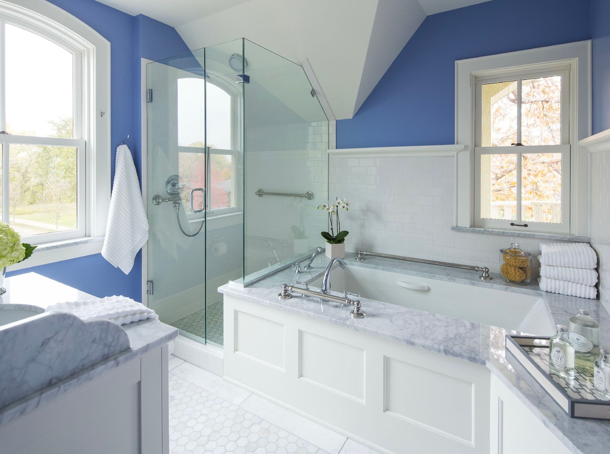 white bathroom with tub and shower with blue walls