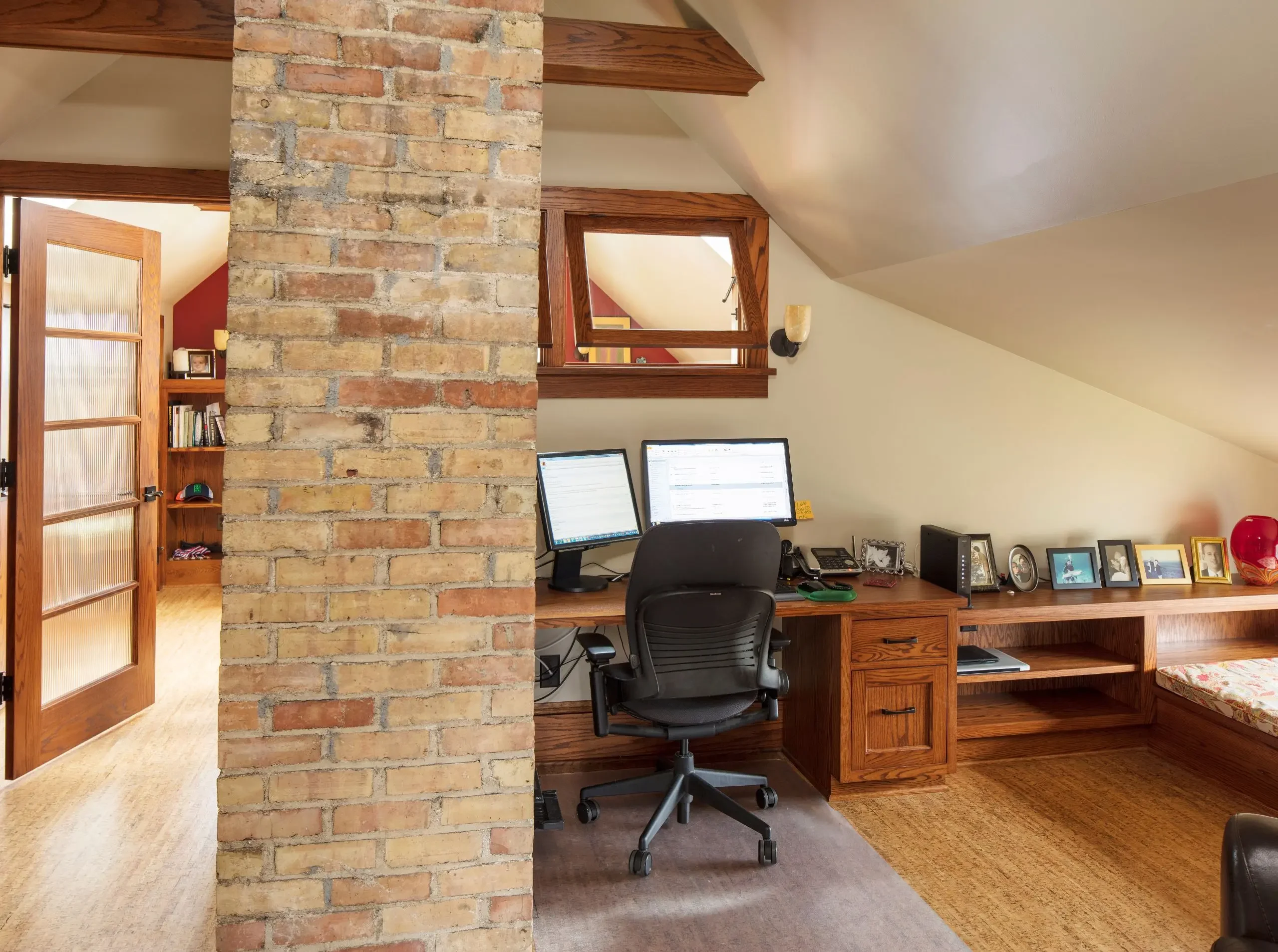 exposed brick column, angled ceilings with built in desk