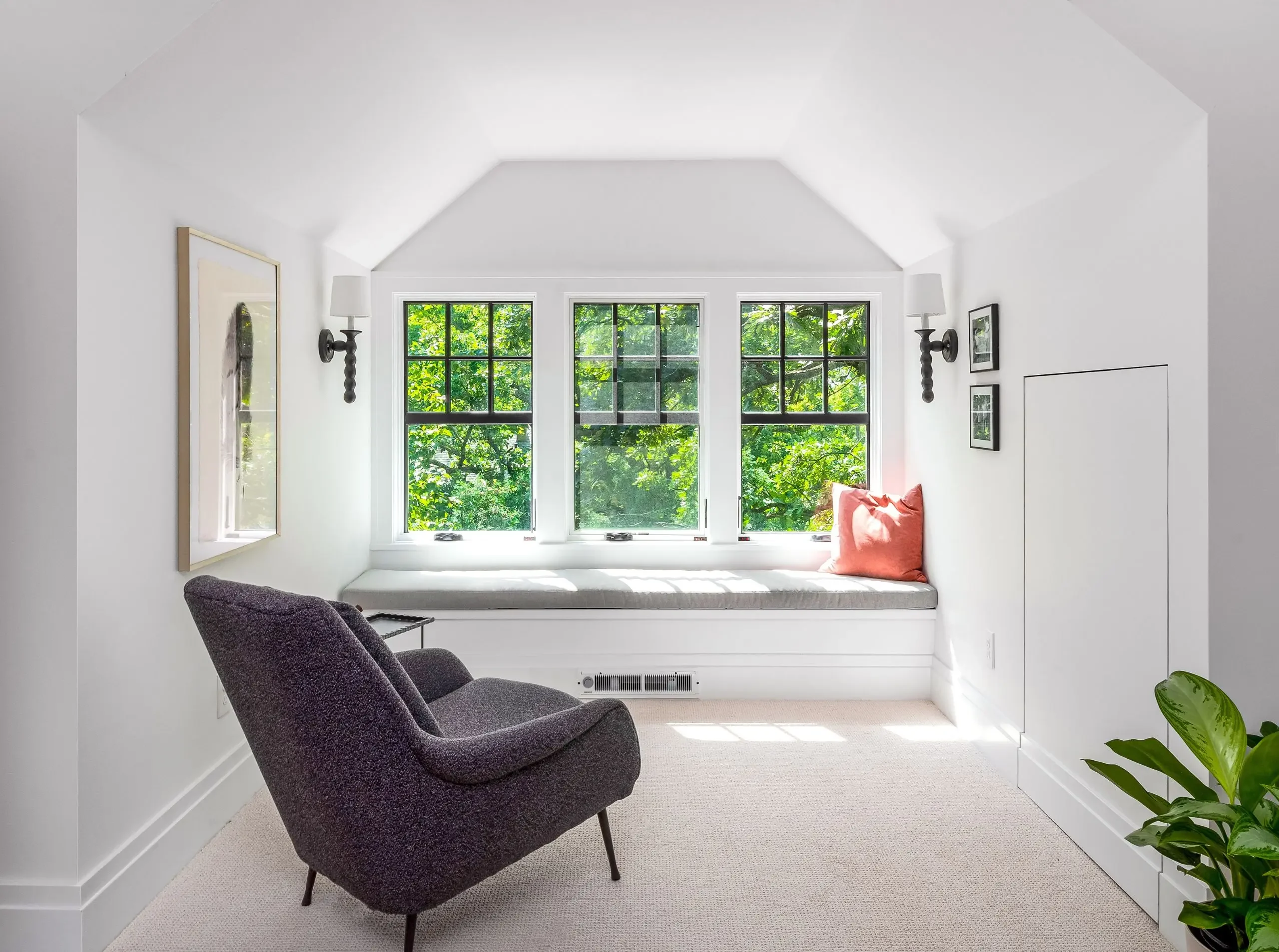 built-in bench and dormer windows in an attic bedroom