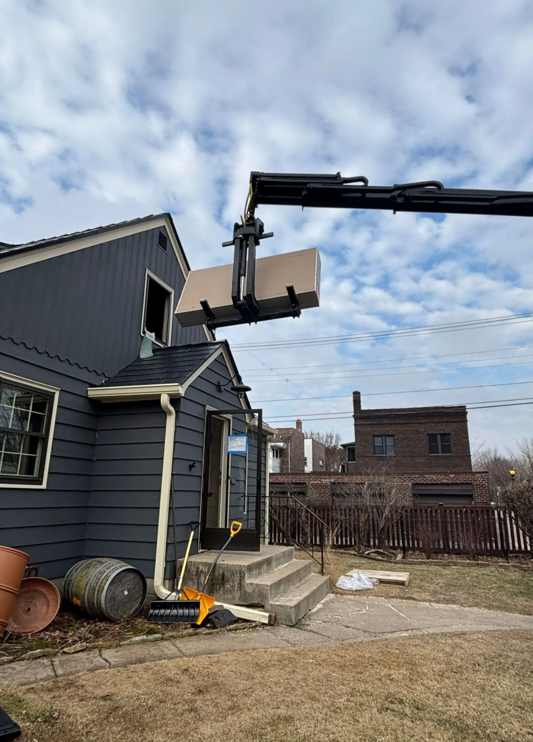 Drywall delivery through attic window during remodel, Macalester-Groveland St. Paul