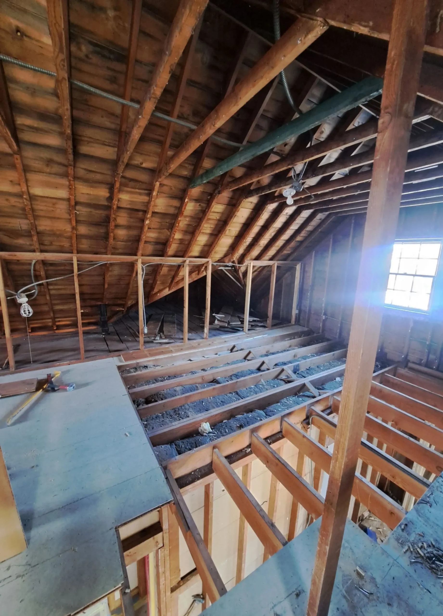 Attic remodel in progress showing exposed framing