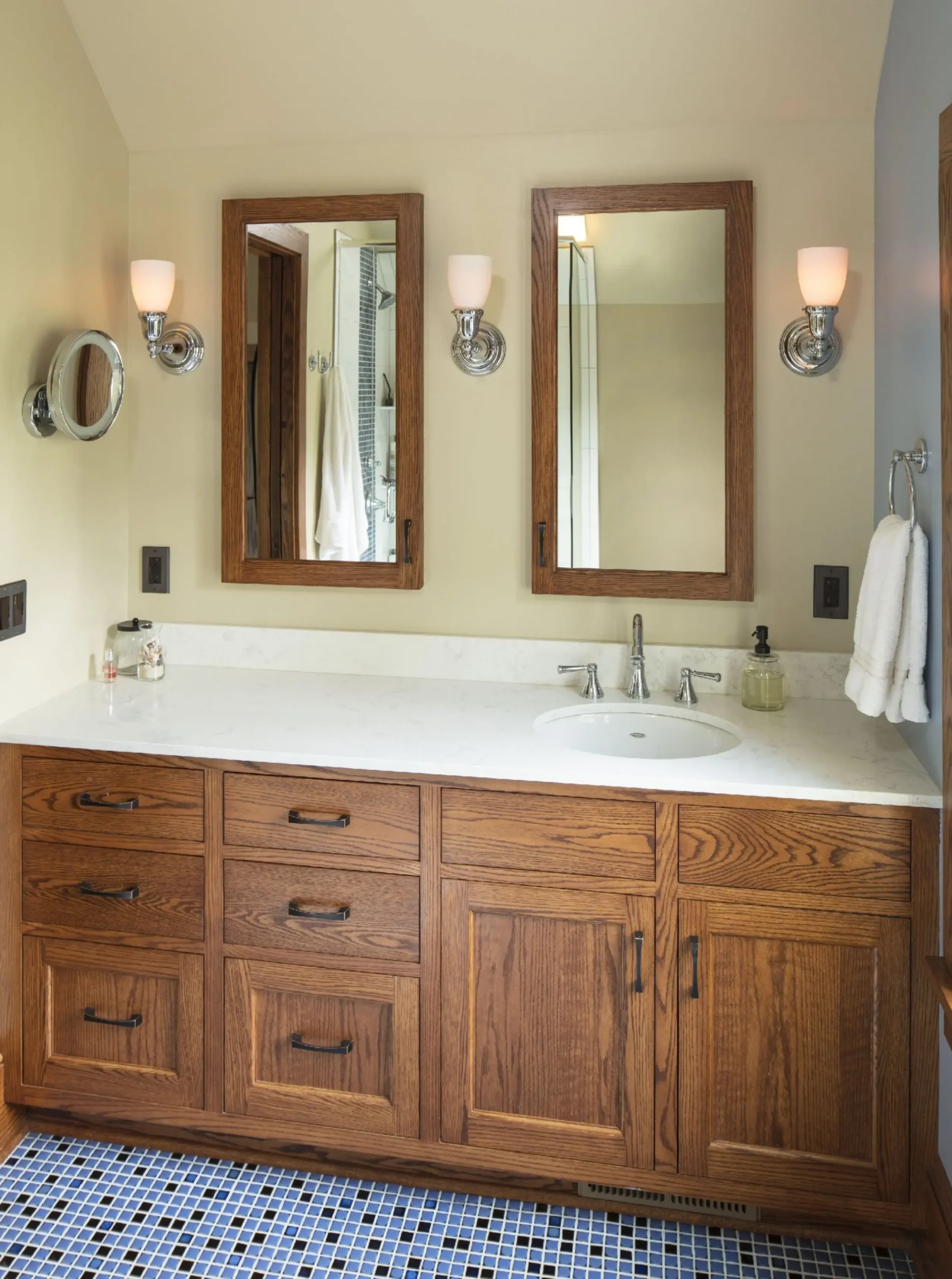 Attic bathroom with custom vanity and shower designed beneath a sloped ceiling.