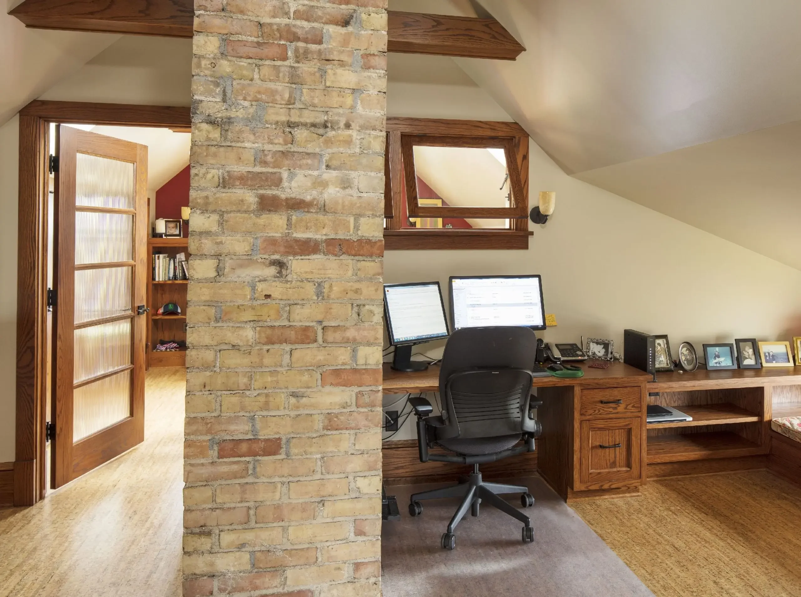Home office designed around an existing brick chimney with custom built-in shelving.