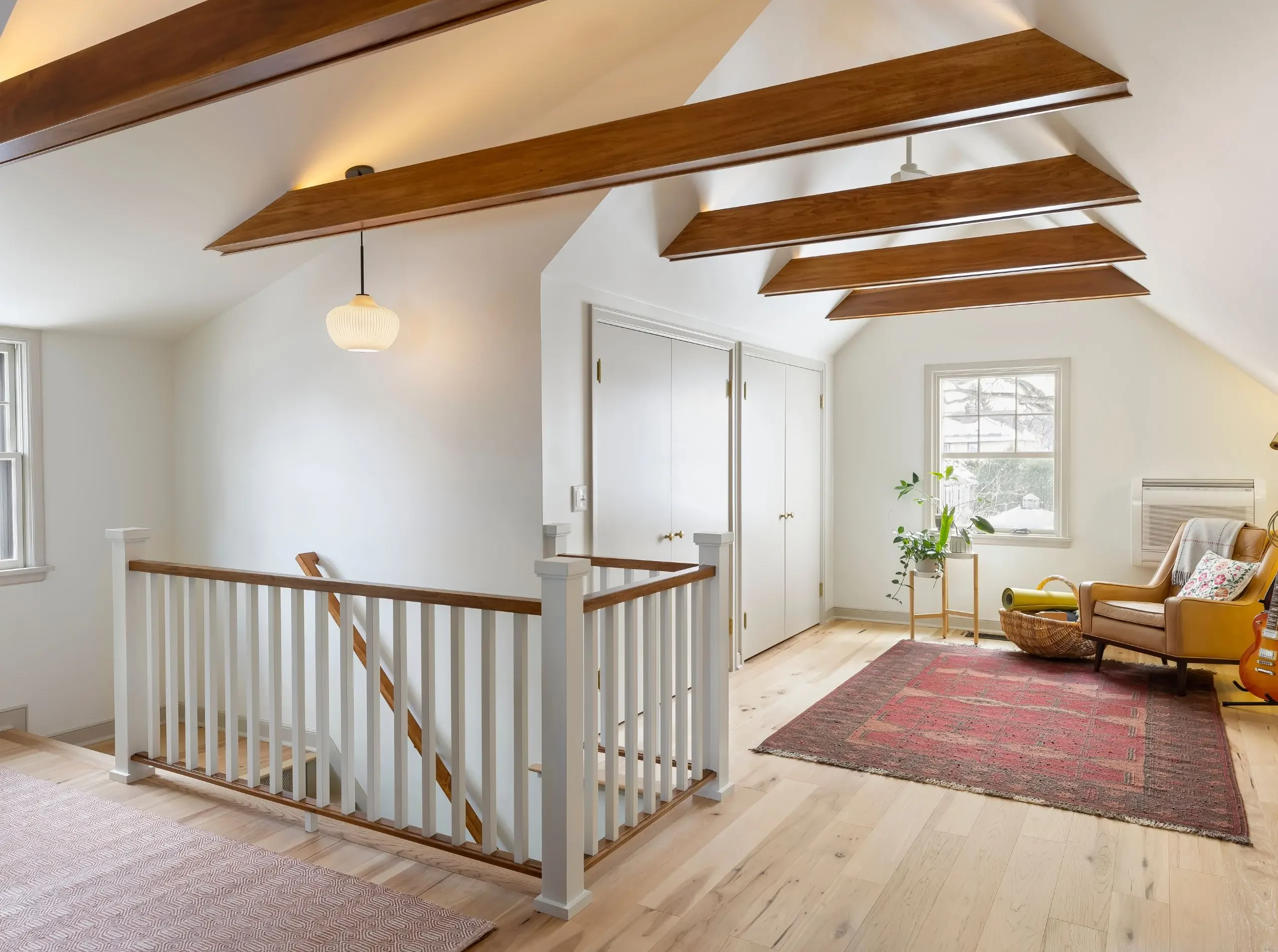 Remodeled attic featuring comfortable living space with architectural character.