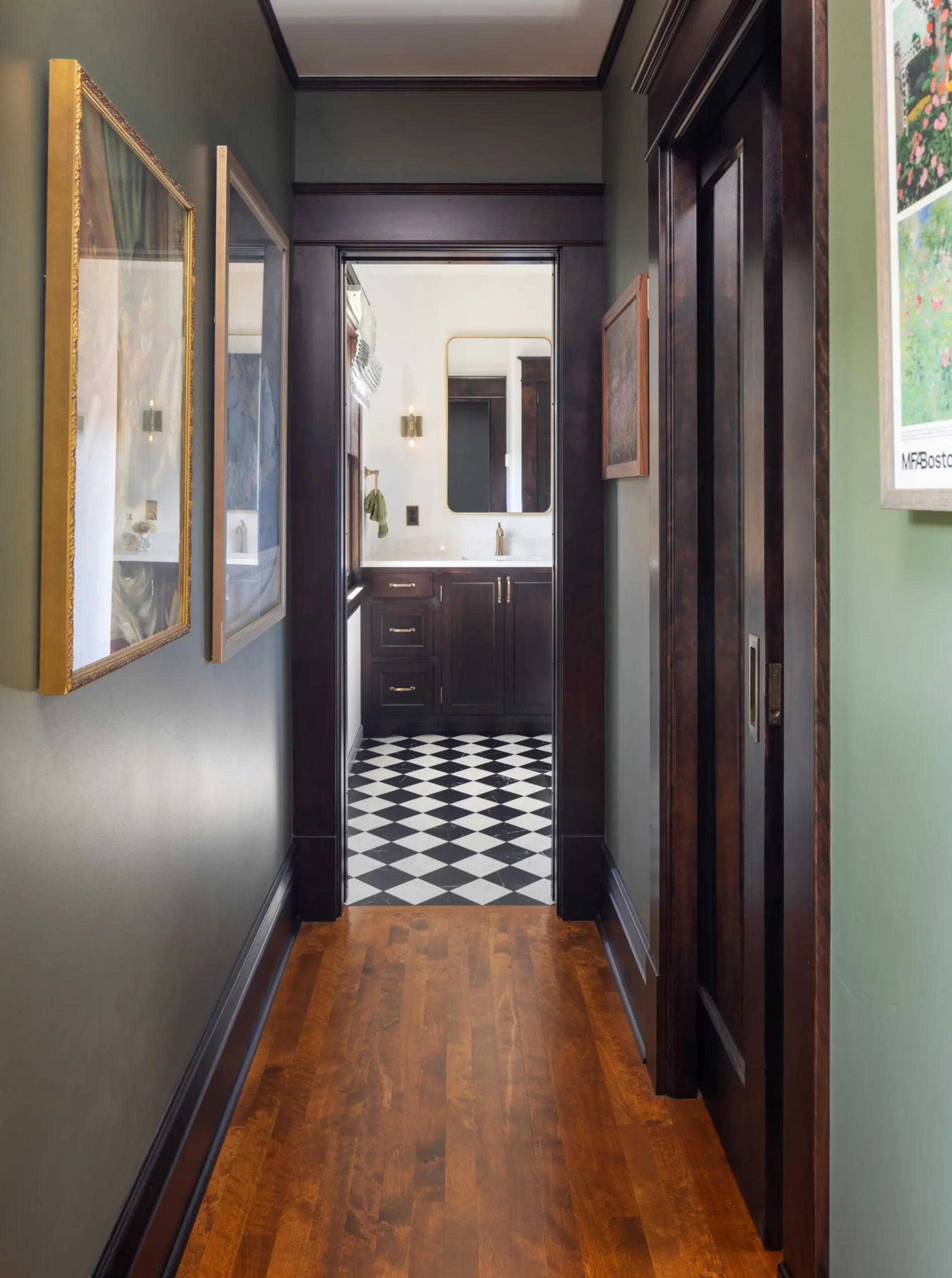 hallway of a primary suite that connects the bedroom to the walk in closet and bathroom